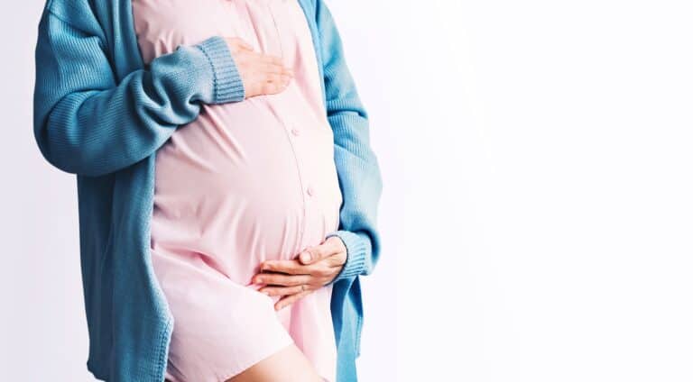 pregnant woman holding abdomen future pregnancy liposuction