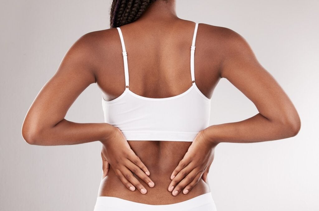black woman touching toned back