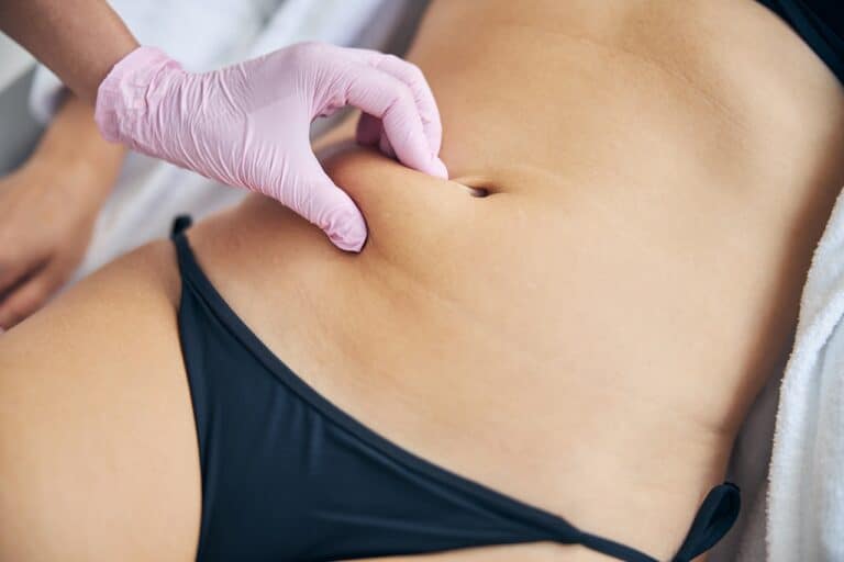 examining adult woman belly