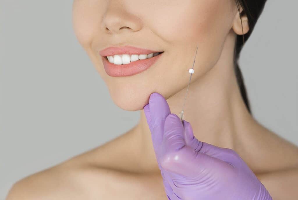 surgeon gloves touching patient chin
