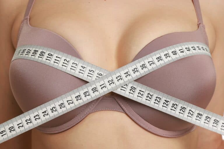 woman measuring breasts