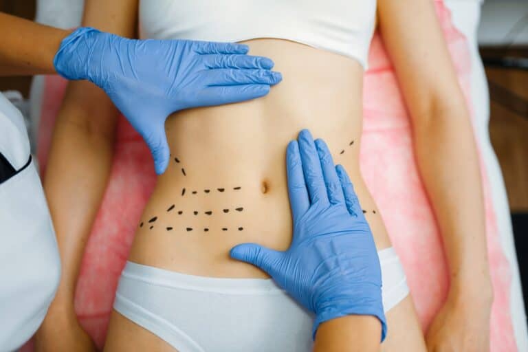 doctor hands on female patient midsection