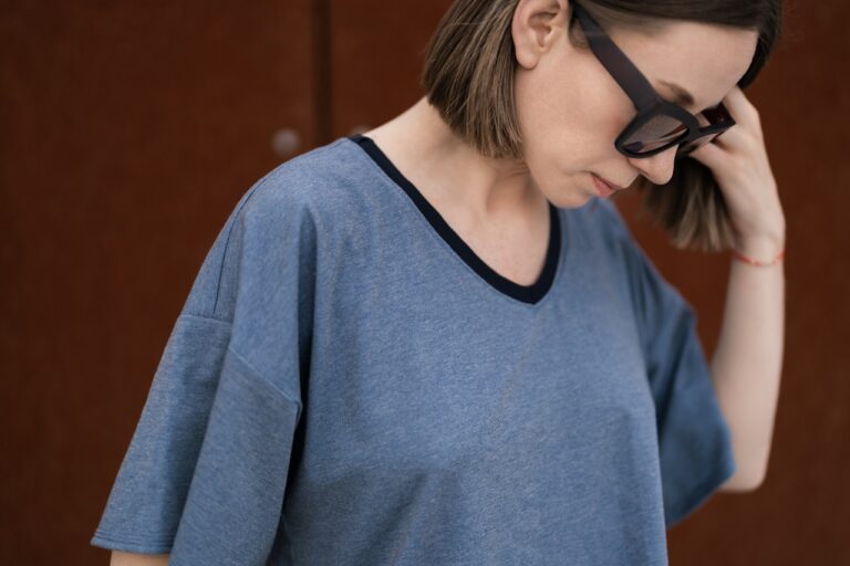 woman in loose clothing and shades