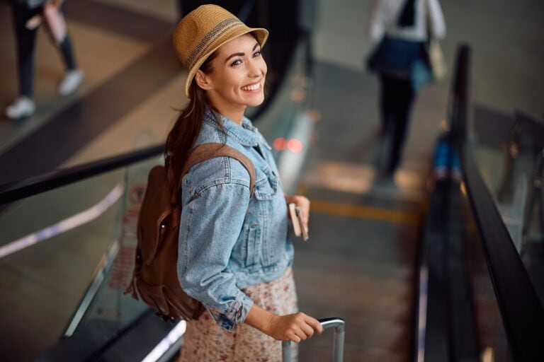 happy female tourist in the escalator