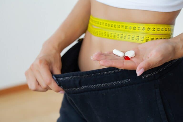 yellow tape measure and weight loss drugs