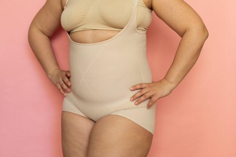 fat woman hands on hips wearing compression garment
