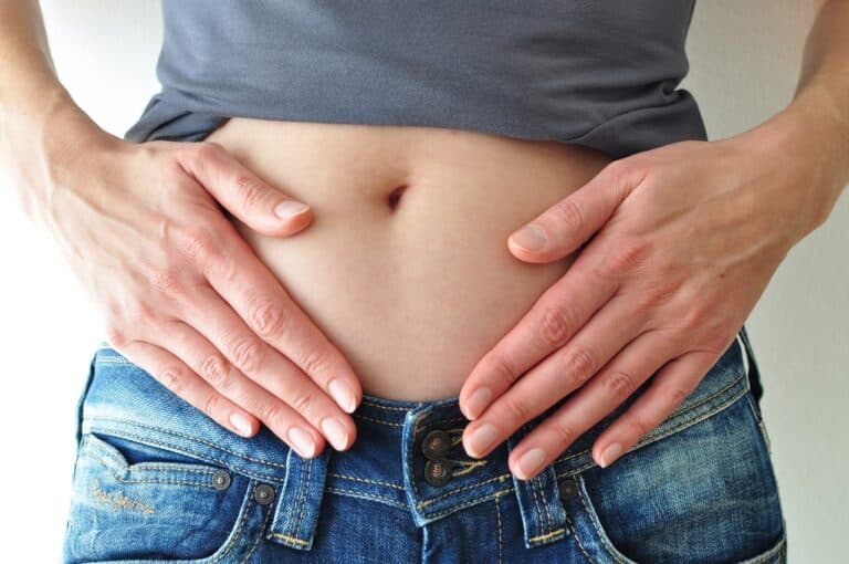 woman's hands on her midsection